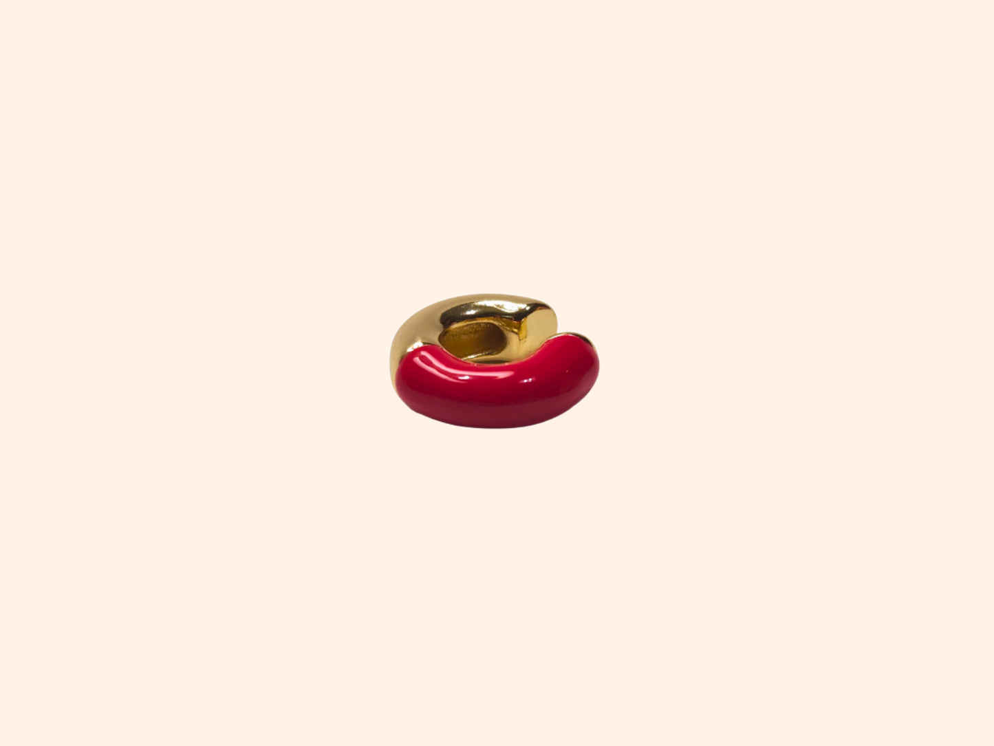 Two-toned ear cuffs by Roots Jewellery, featuring a gold and white ring-shaped ceramic design with a gold finish on a light beige background.