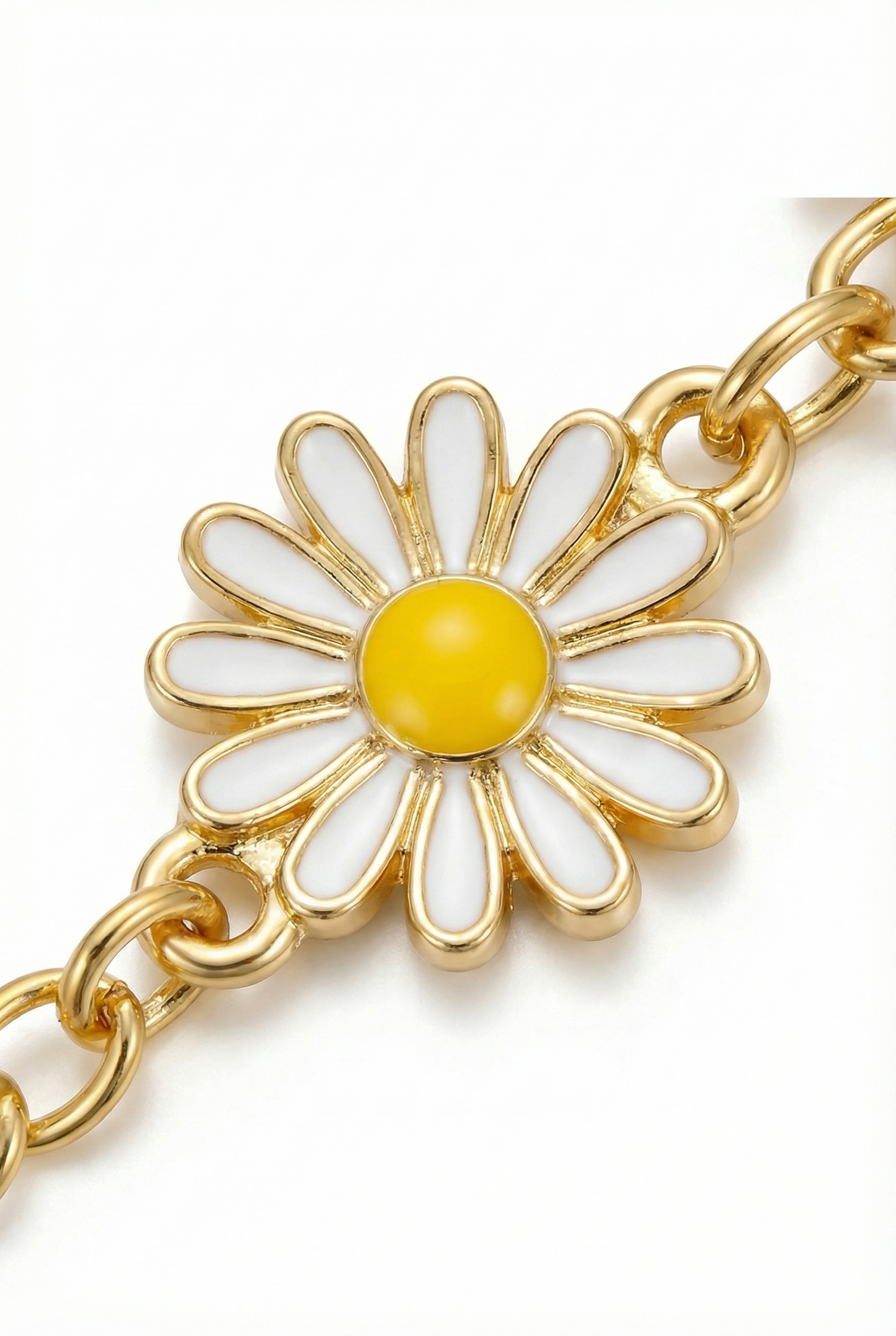 Gold chain bracelet with a daisy charm featuring a yellow center and white petals on a white background.