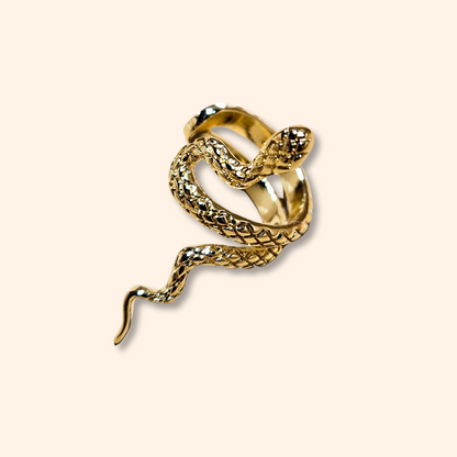 Displayed on a plain background, the captivating gold-plated design from Roots Jewellery, featuring intricate scales and an elevated head, mirrors the allure of their Serpentine Ear Cuff with its detailed snake artistry.