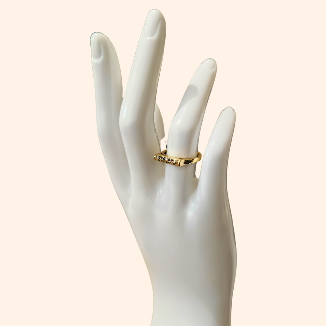 Introducing the Rainbow Signet Gold Ring by Roots Jewellery: an open-ended gold ring with a rectangular top adorned with three small rainbow-colored zircons, ideal for the fashion-forward individual.