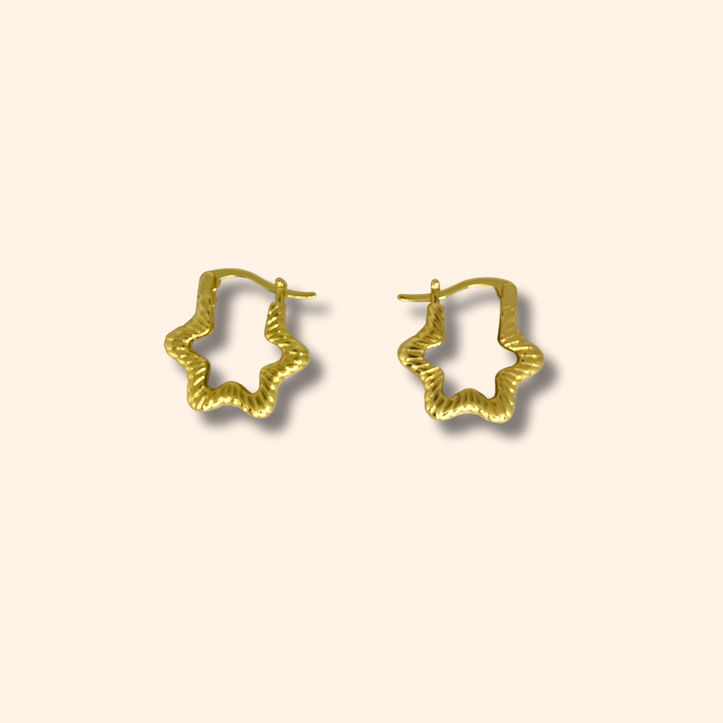 Roots Jewellery's Gold Star Hoop Earrings showcase a captivating star design set against a light background, expertly rhodium-plated for enhanced durability and shine.