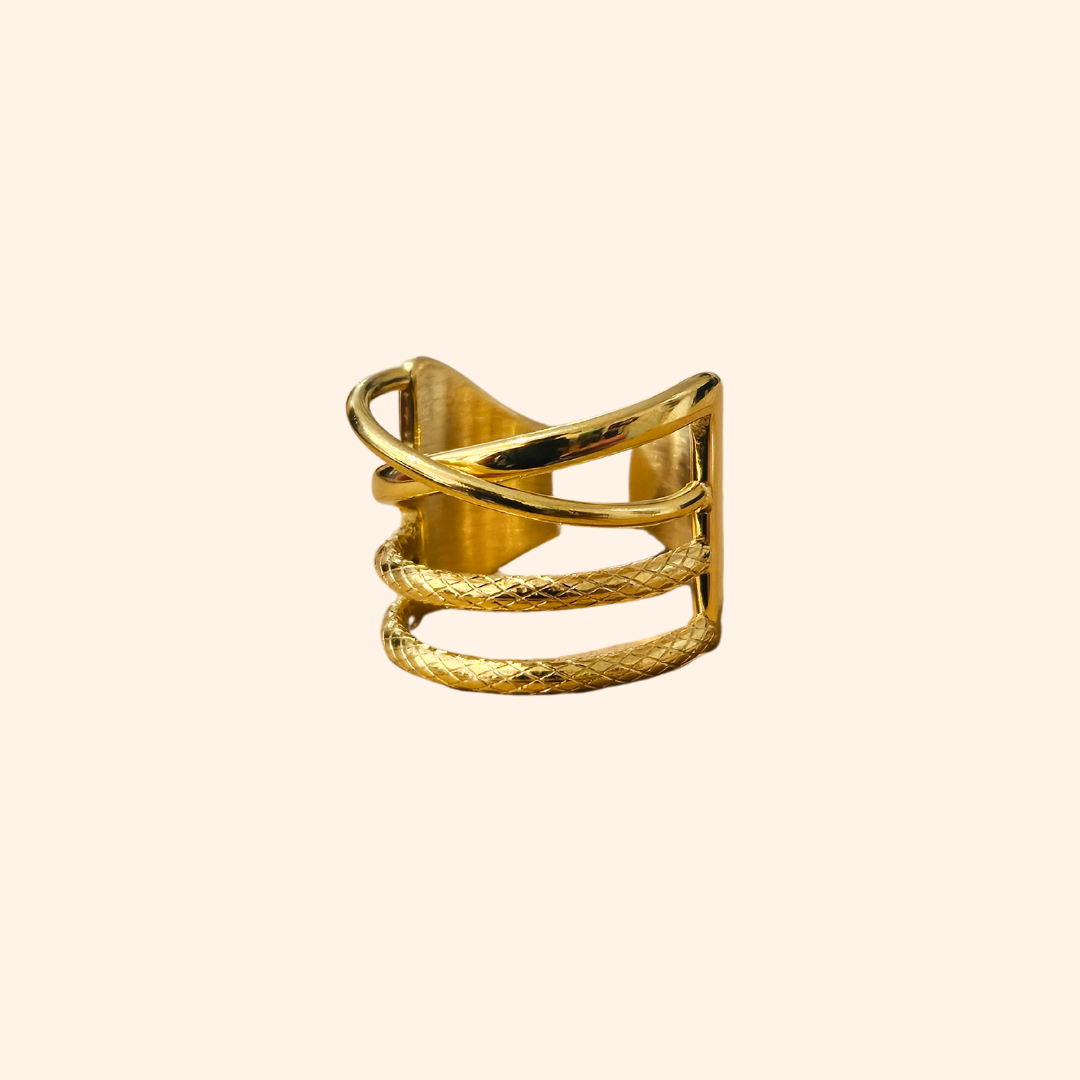 The Intertwined Gold Ring from Roots Jewellery showcases timeless elegance with its wide band and contemporary, intersecting geometric design.