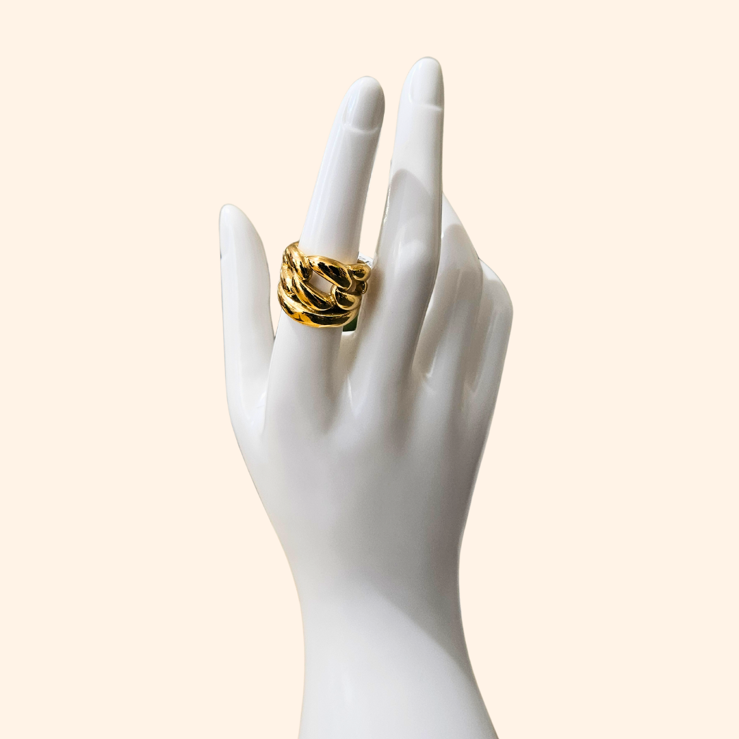 Indulge in the charm of luxury with the Roots Jewellery Chunky Chain Gold Ring, meticulously crafted against a simple backdrop.