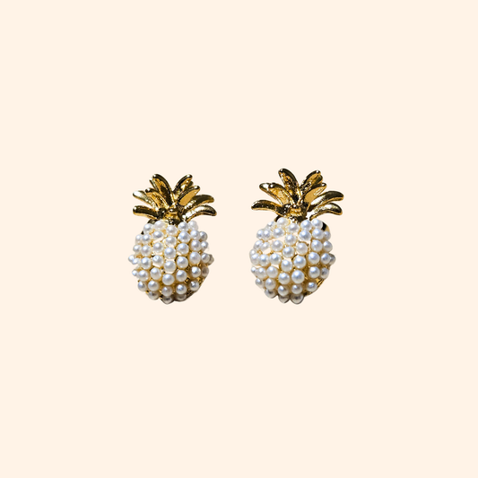 The Pineapple Earrings by Roots Jewellery exude a tropical flair against a light background.