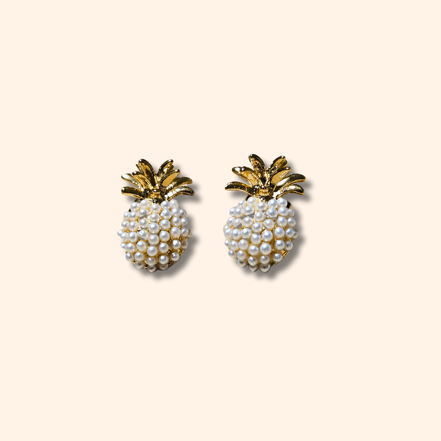 The Pineapple Earrings by Roots Jewellery exude a tropical flair against a light background.