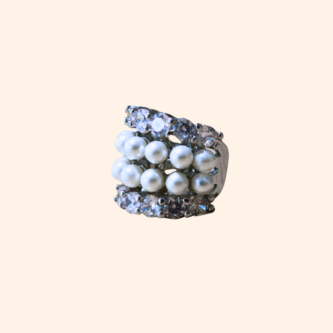 Introducing the Luxe Pearl & Zircon Stainless Steel Ear Cuff by Roots Jewellery, showcasing sleek rows of lustrous white pearls and glistening zircons set against a polished backdrop.