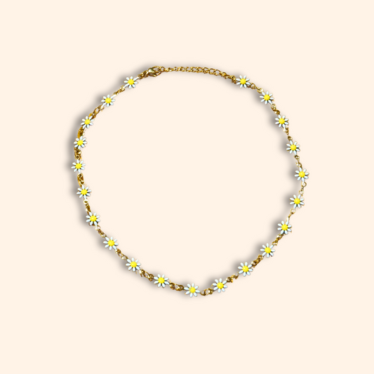 A stunning fashion accessory, the Little Daisy Flower Choker Necklace by Roots Jewellery features delicate gold-linked white daisy flowers, elegantly displayed on a plain background.