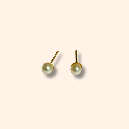 Introducing the Earring Set - Orange Hearts by Roots Jewellery: three exquisite pairs of earrings, including orange heart-shaped, gold flower-shaped, and white pearl studs, all beautifully displayed on a simple backdrop.