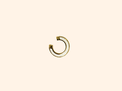 The Single Colour C Shape - Ear Cuff by Roots Jewellery is a small gold and teal ear cuff that elegantly showcases its intricate gold design, set against a beige background, highlighting this exquisite jewelry accessory.