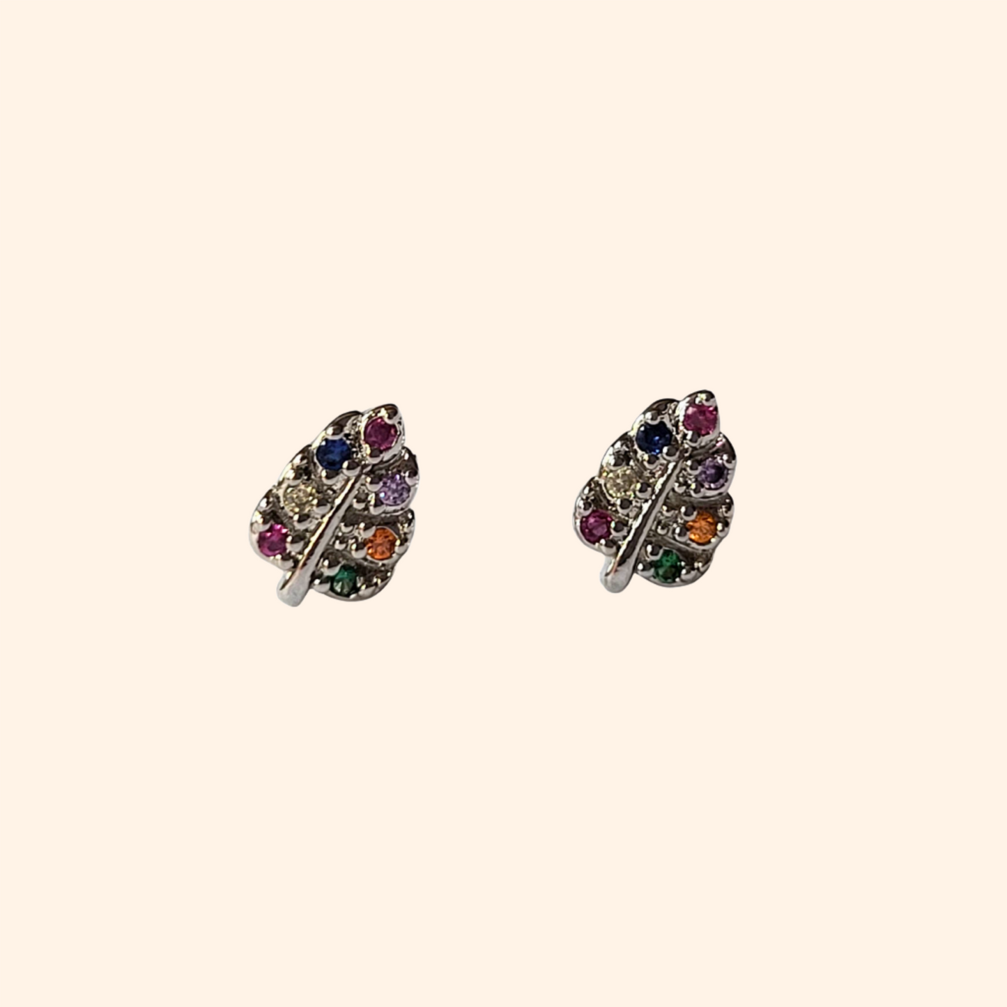 The Colorful Silver Leaf earrings from Roots Jewellery feature vibrant gemstones arranged in delicate lines, offering a sophisticated touch with playful yet refined colorful accents.