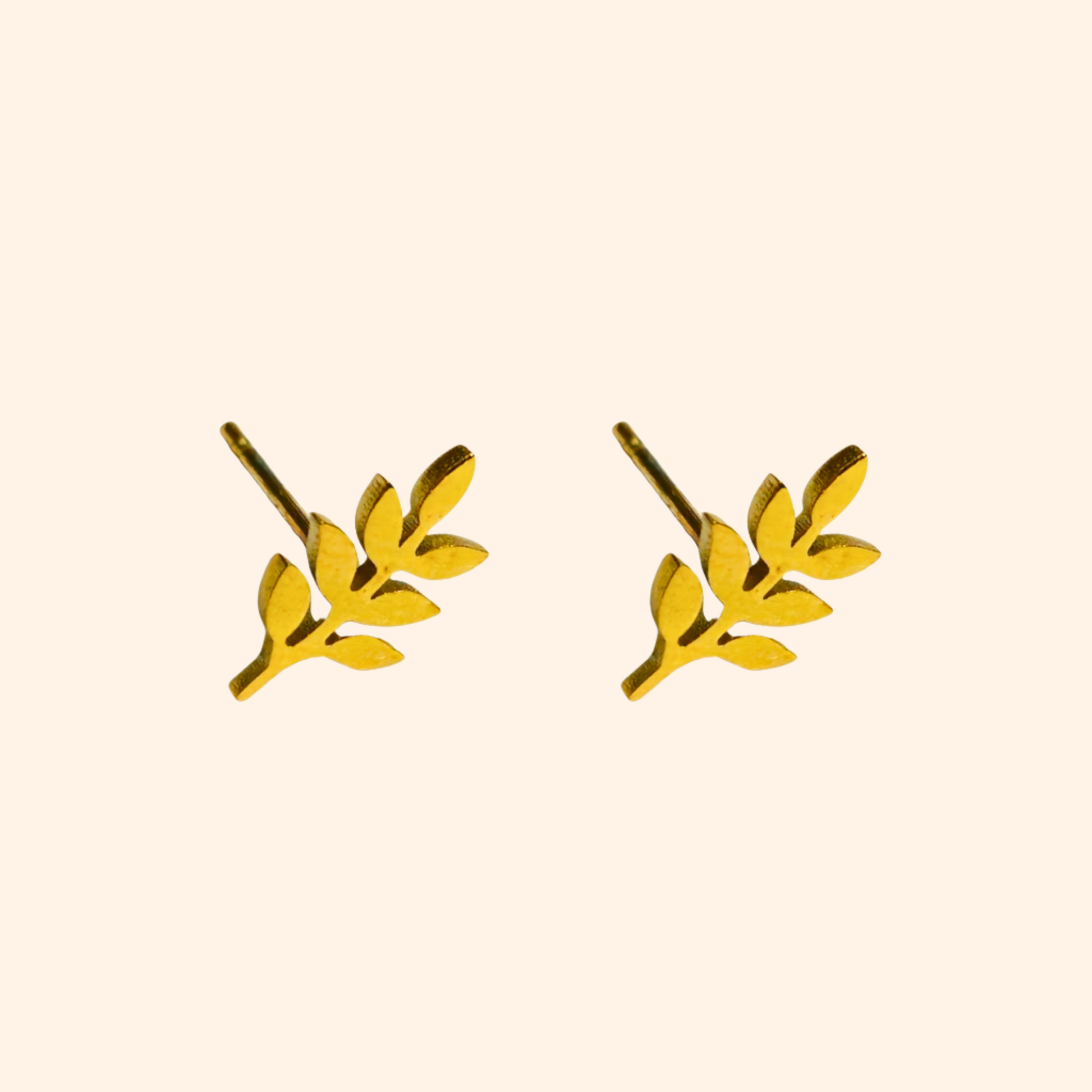 Golden Leafs Earrings by Roots Jewellery: A stunning pair of gold leaf-shaped stud earrings crafted from high-quality stainless steel, elegantly showcased on a plain background.