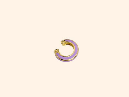 The Single Colour C Shape - Ear Cuff by Roots Jewellery is a small gold and teal ear cuff that elegantly showcases its intricate gold design, set against a beige background, highlighting this exquisite jewelry accessory.