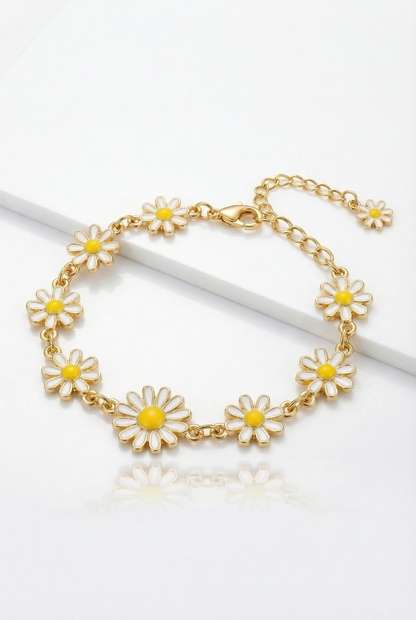 Gold bracelet with daisy flower charms on a white background